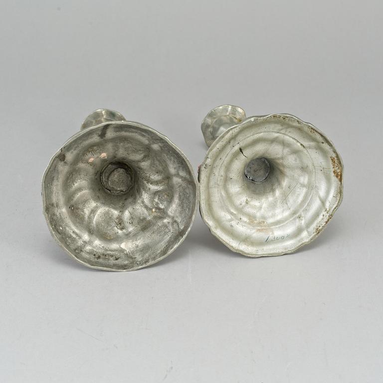 Two pewter rococo candlesticks.