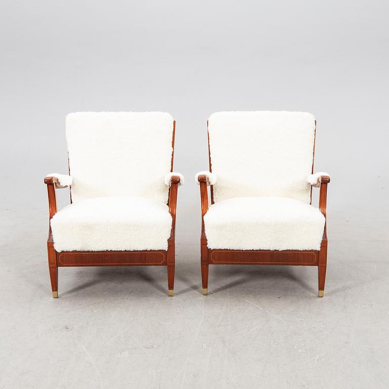 A pair of 1940s cheepskin armchairs.