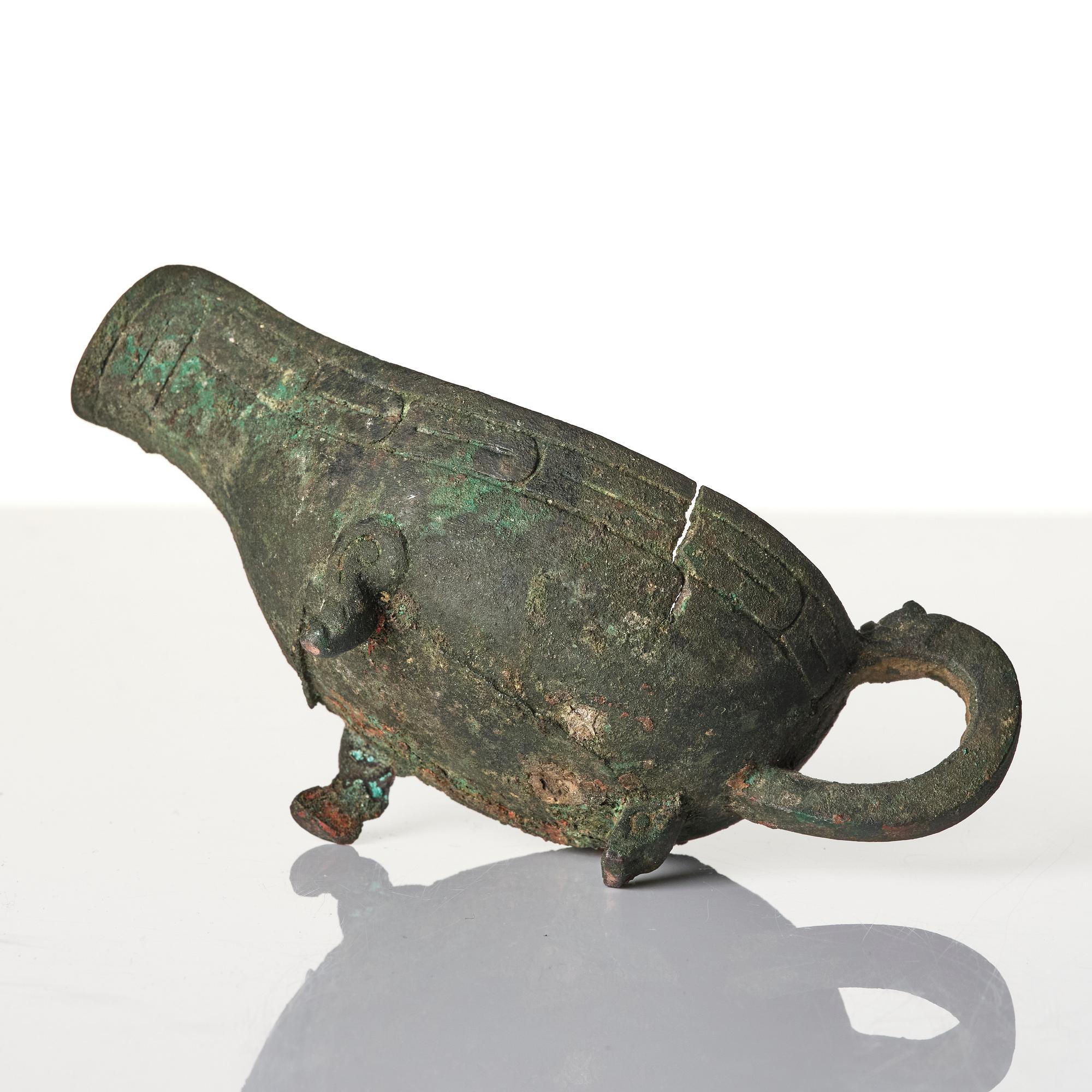 A Chinese brushpot, Qing dynasty, circa 1900. An archaistic bronze ewer and a silvered South East Asian bowl with stand.