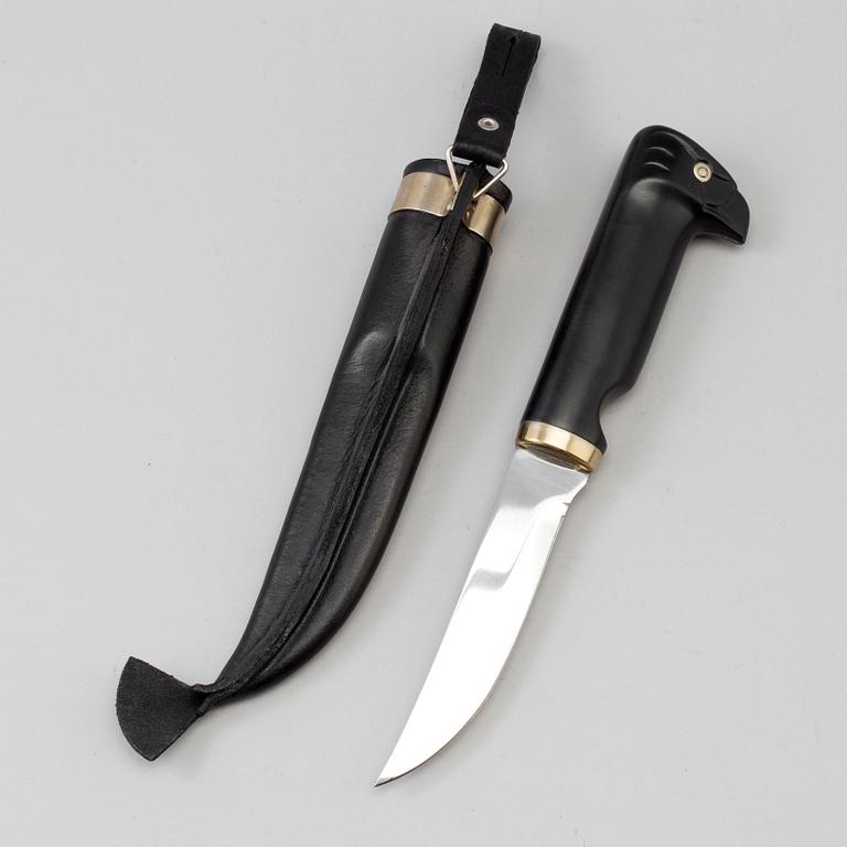 A Finnish puukko knife in leather sheath, for Fiskars, late 20th century.