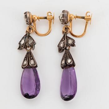 A pair of 14K gold and silver earrings set with faceted amethysts and rose-cut diamonds.