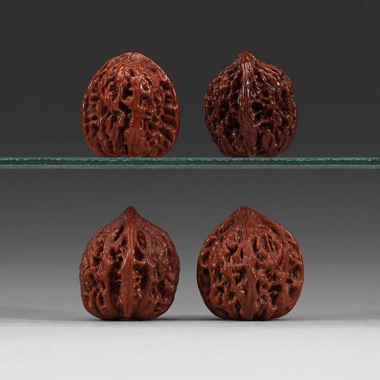 Two pairs of carved walnut hand exercisers, late Qing dynasty (1644-1912).