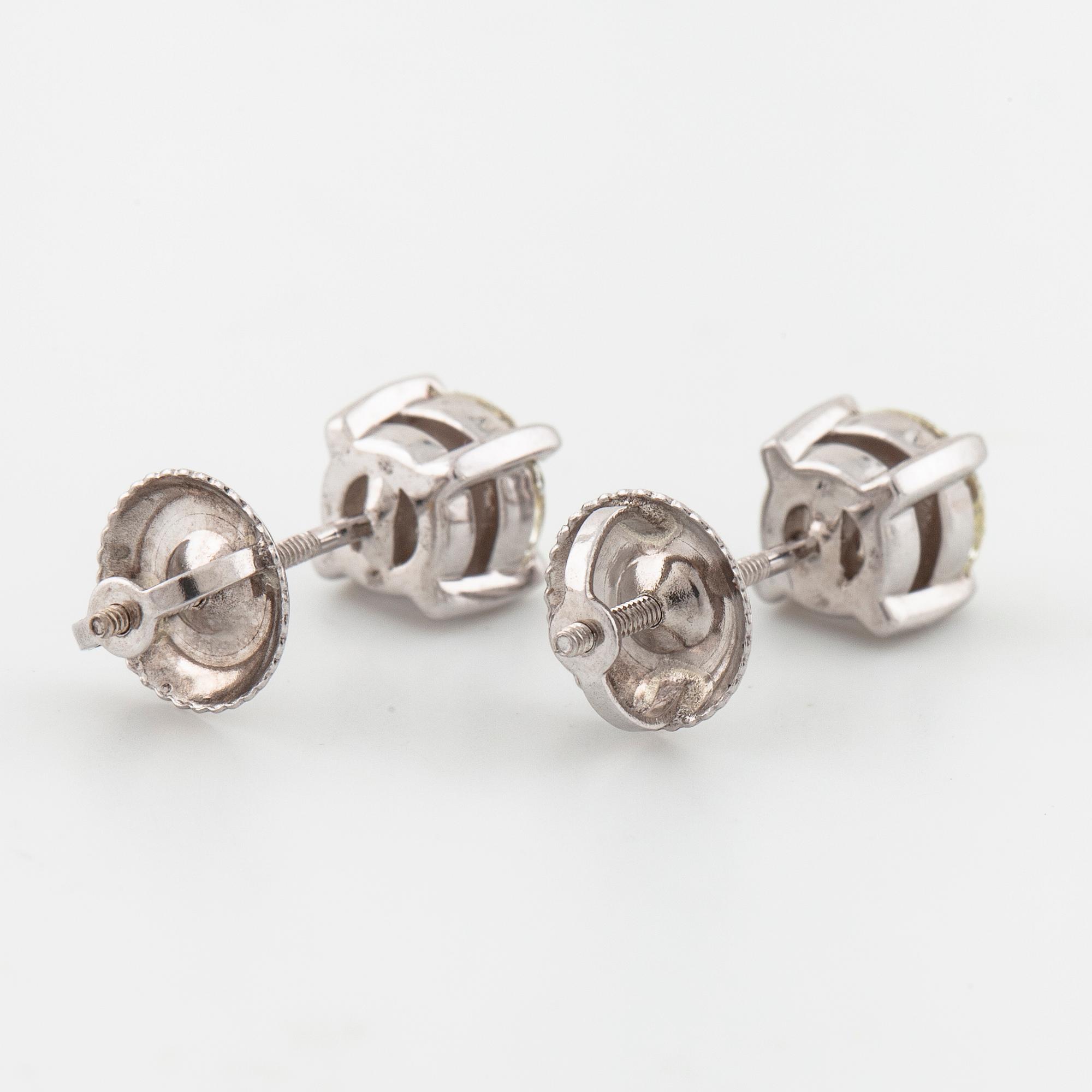 A pair of brilliant cut diamond earrings.