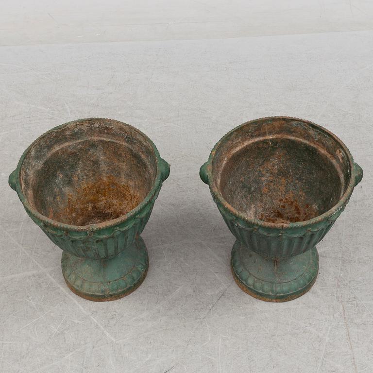 A pair of early 20th century iron garden urns.