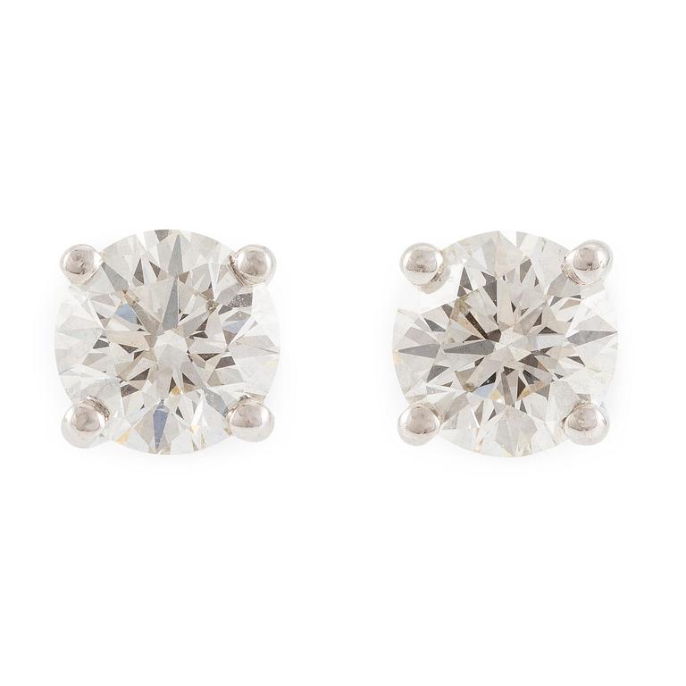 A pair of earrings in 18K white gold set with two round brilliant-cut diamonds, likely Tiffany & Co.