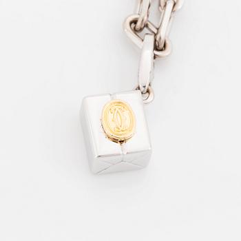 An 18K gold and white gold Cartier necklace with a charm.