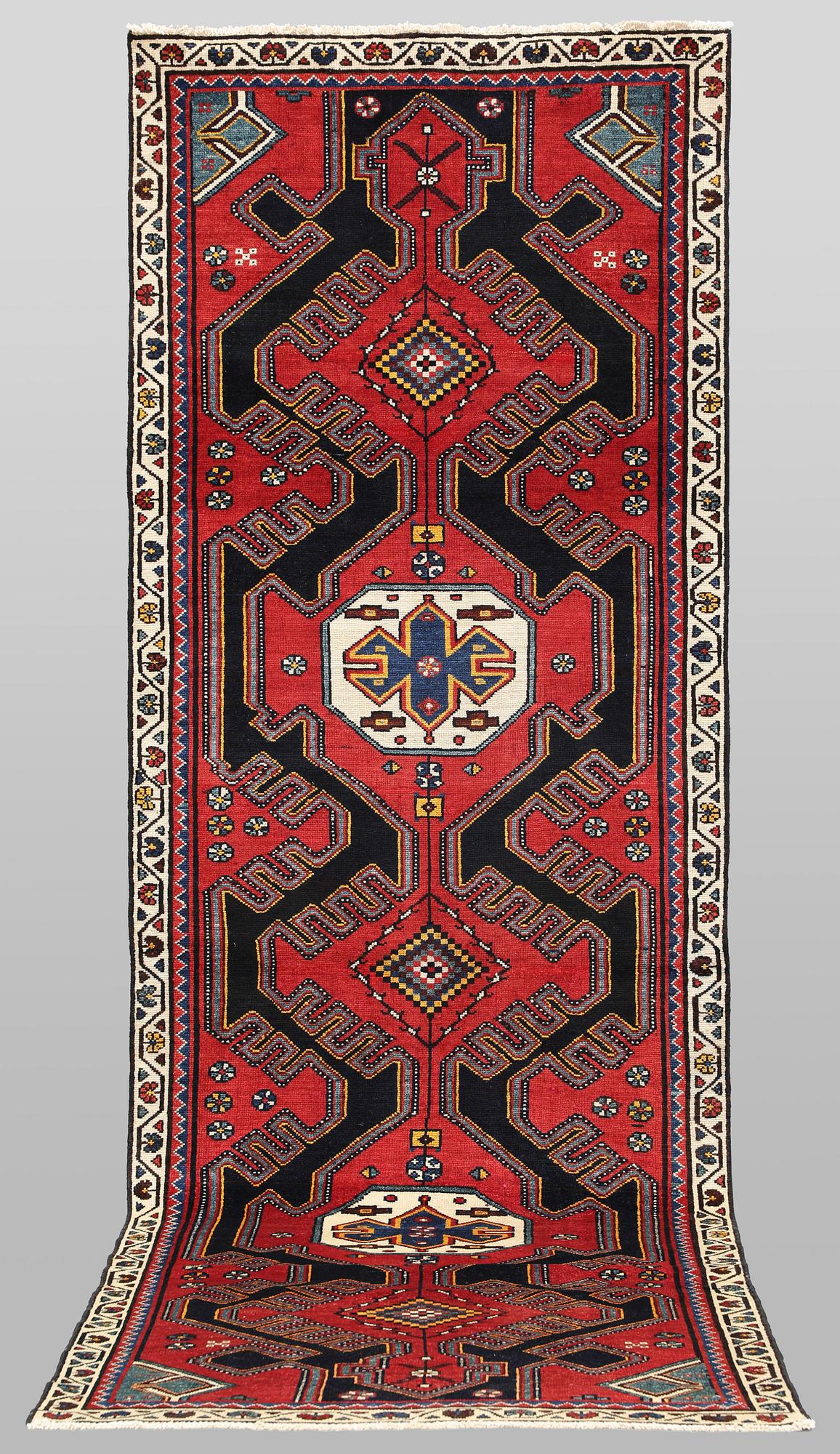A semi-antique runner carpet, 295 x 100 cm.