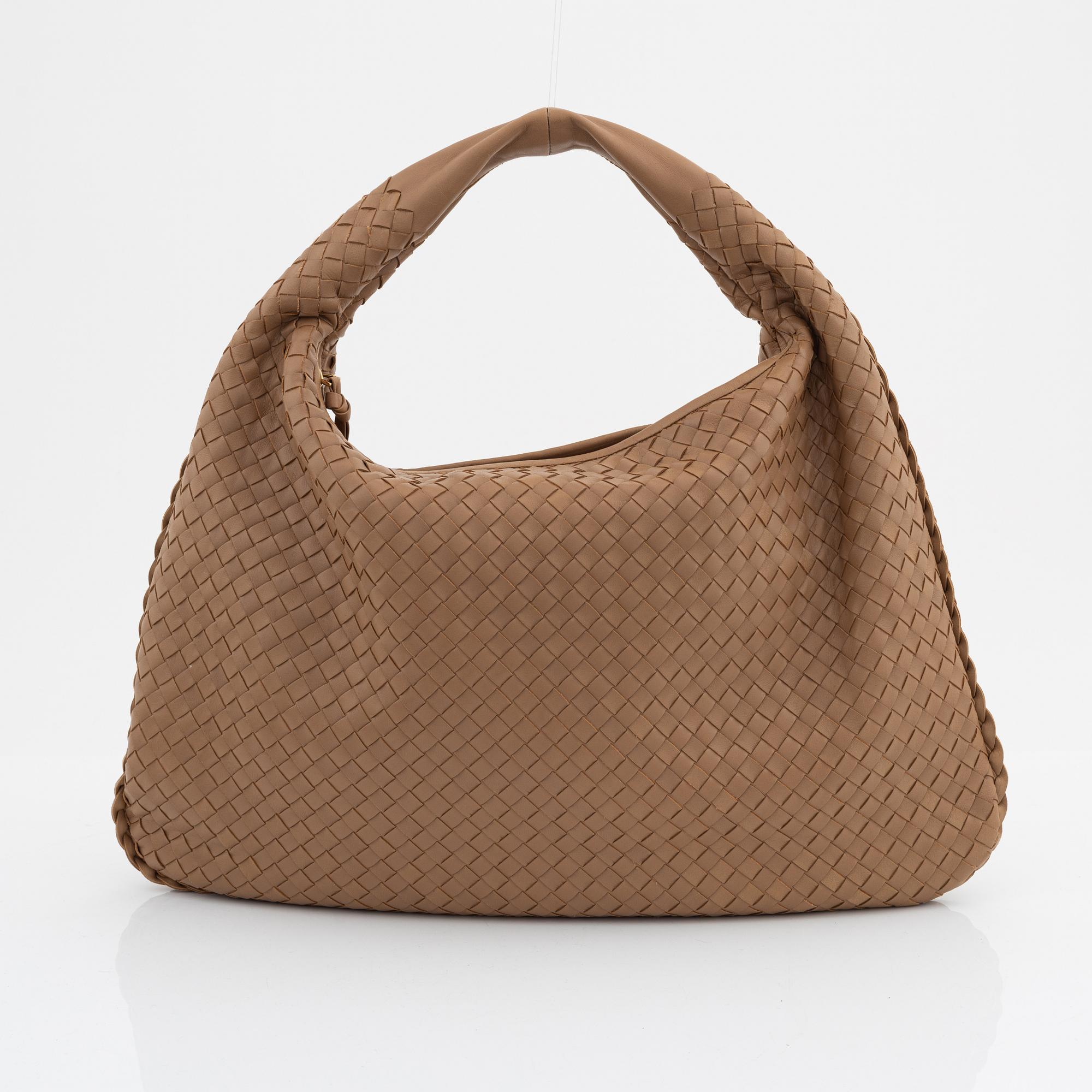 Bottega Veneta, a beige intrecciato leather bag.
