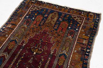 An antique rug, possibly Anatolian, approx. 170 x 102 cm.