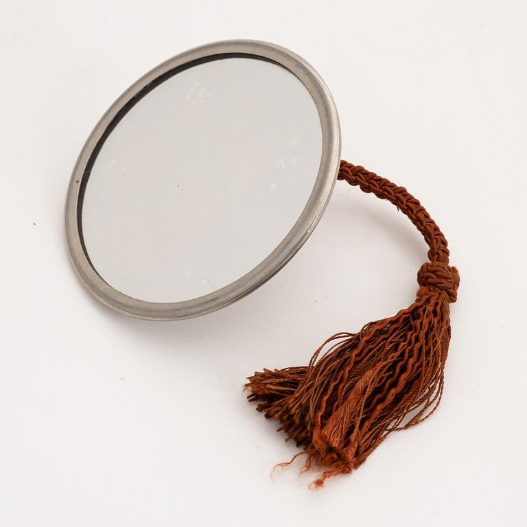 A 1930s hand held pewter mirror.