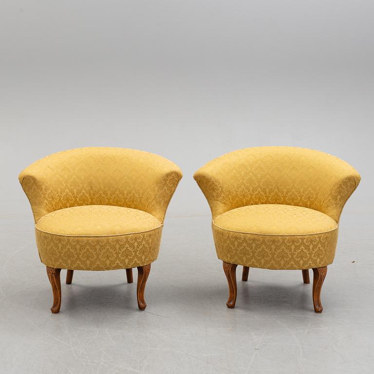 An early 20th century pair of rococo style easy chairs.