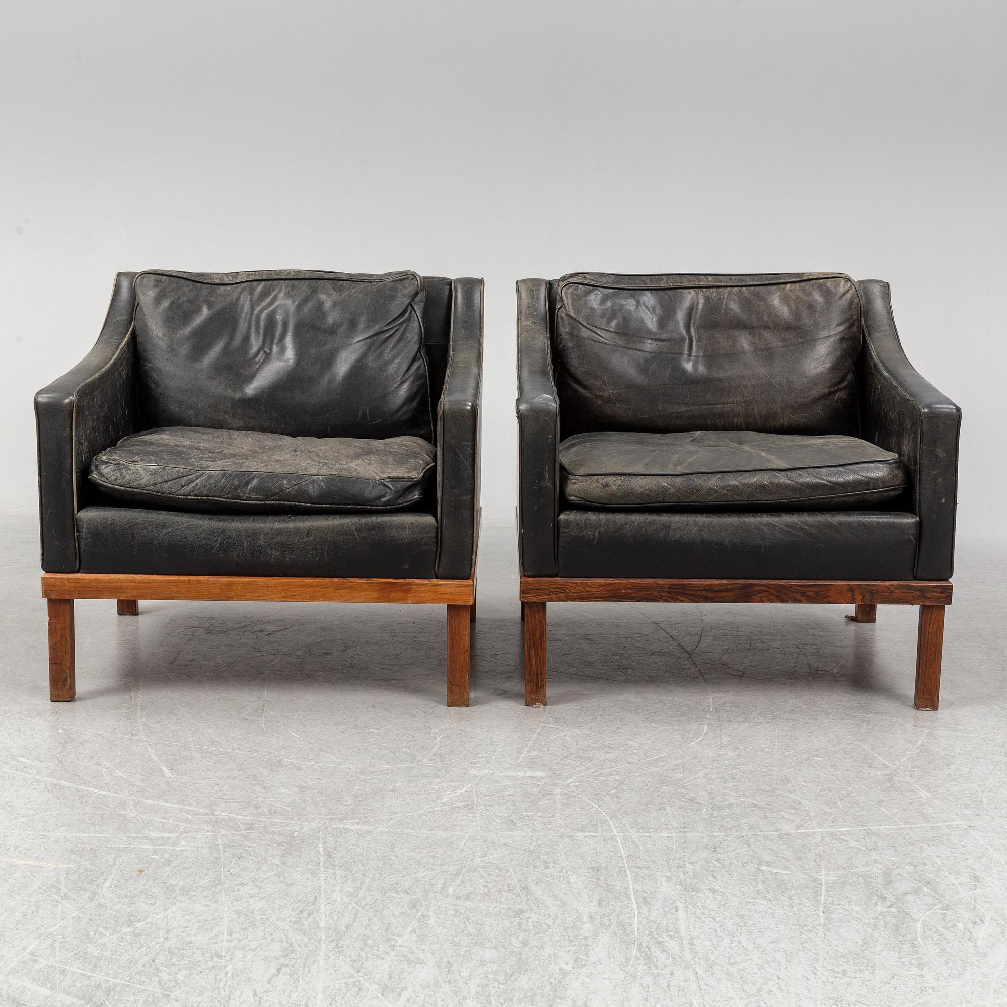 A pair of "The President" black leather armchairs by Ingemar Thillmark for OPE-möbler, Sweden.