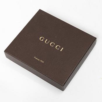 Gucci, wallet and belt.