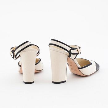 MIU MIU, a pair of creme white canvas sandals.