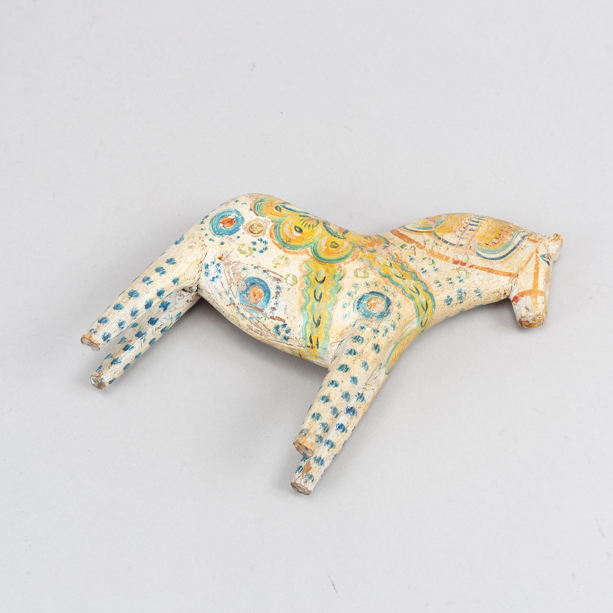 A painted Swedish wooden horse from the first half of the 20th century.