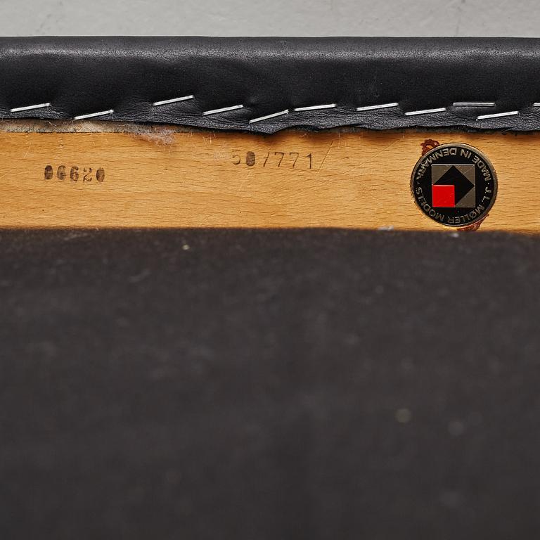 Niles Otto Møller, a rosewood veneered table with four chairs, JL Møller, Denmark, 1950's/60's.