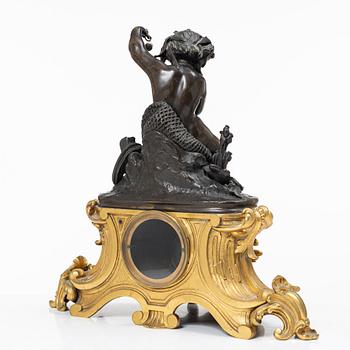 A Rococo style mantle clock and pair of candelabra, France, late 19th Century.
