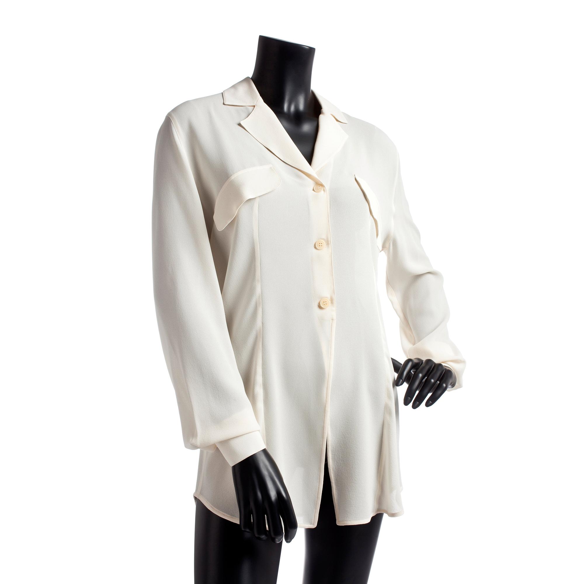 GIORGIO ARMANI, a light beige silk blouse.