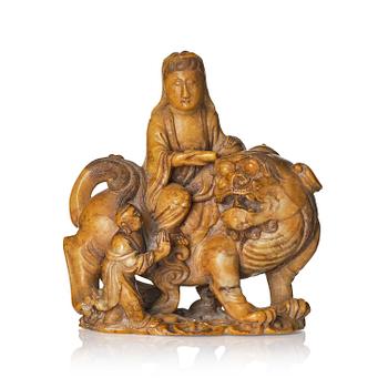 991. A well carved soapstone sculpture of Guanyin seated on Xiezhai, Qing dynasty, 18th/19th century.