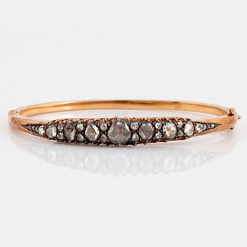 1003. An 18K gold and silver bangle set with rose-cut diamonds.