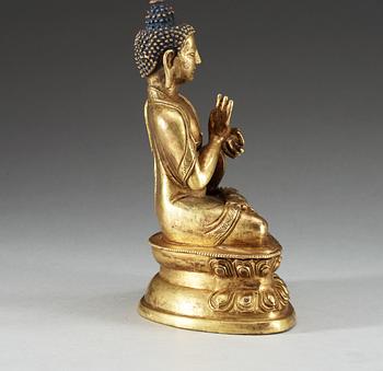 A gilt copper Buddha, presumably Qing dynasty, with Qian Long seven character mark.