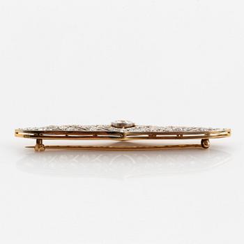 A platinum and 14K gold brooch set with an old-cut diamond weight ca 1.05 cts quality ca H si.