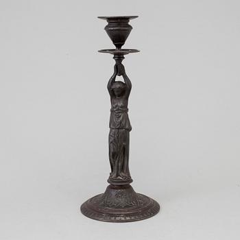A 19th century iron candlestick marked F.L Vombach Offenbach A/M.