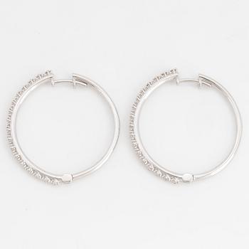 Brilliant-cut diamond hoop earrings.