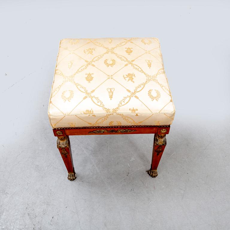 An Empire style mahogany stool around 1900.