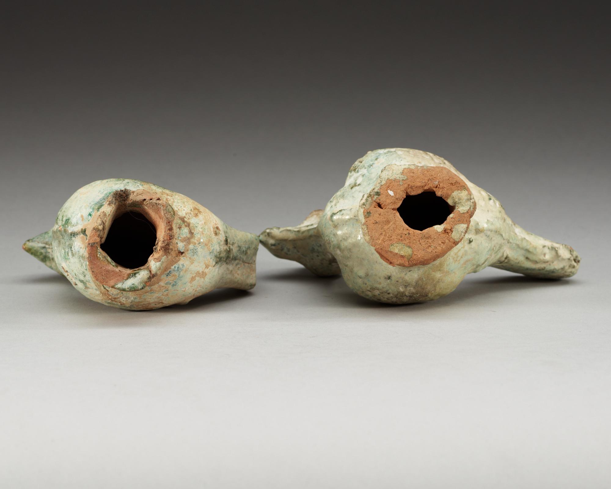 A set of two green glazed pottery models of a rooster and a hen, Han dynasty (206 BC- 220 AD).