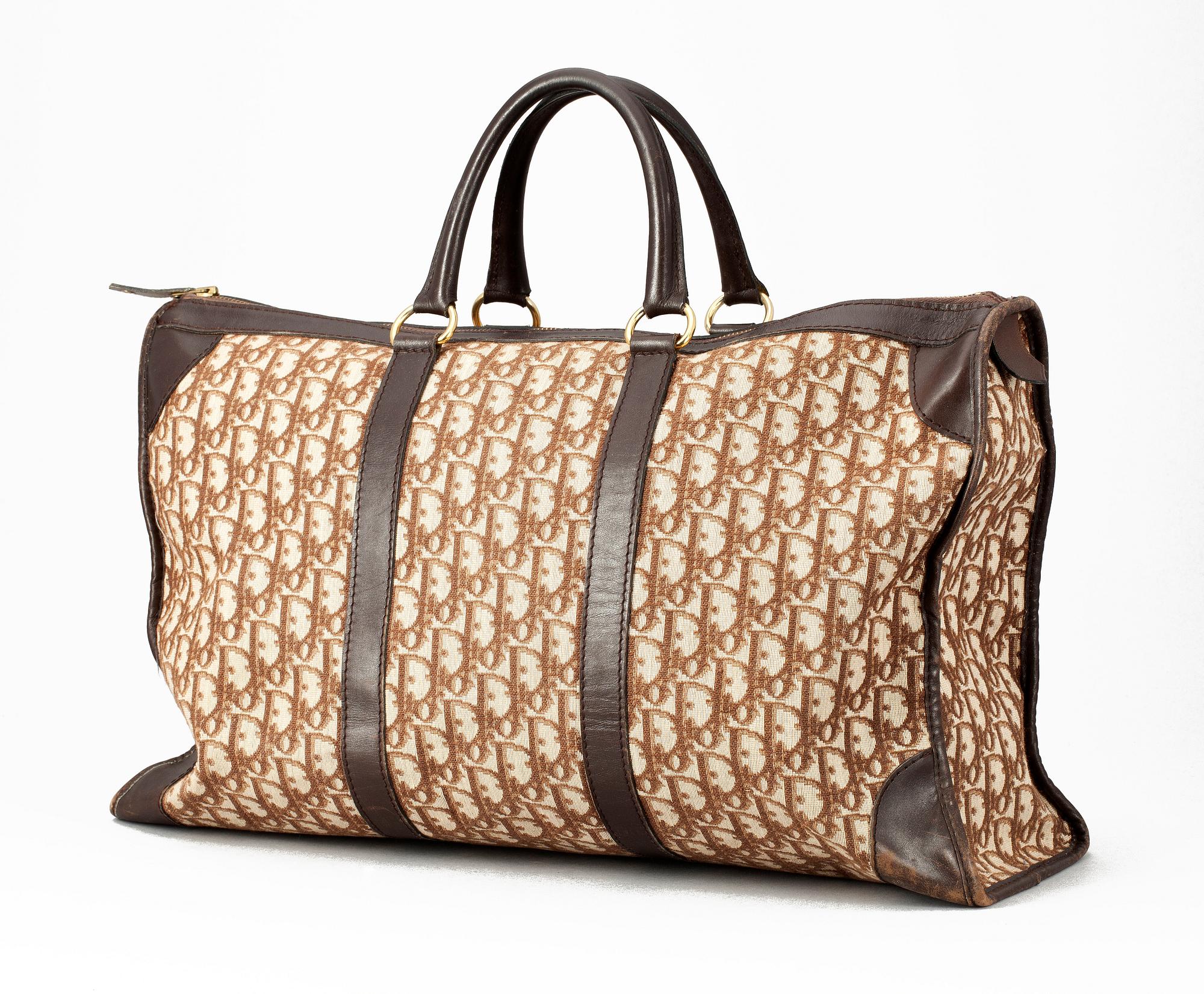 A monogram canvas weekendbag by Christian Dior.