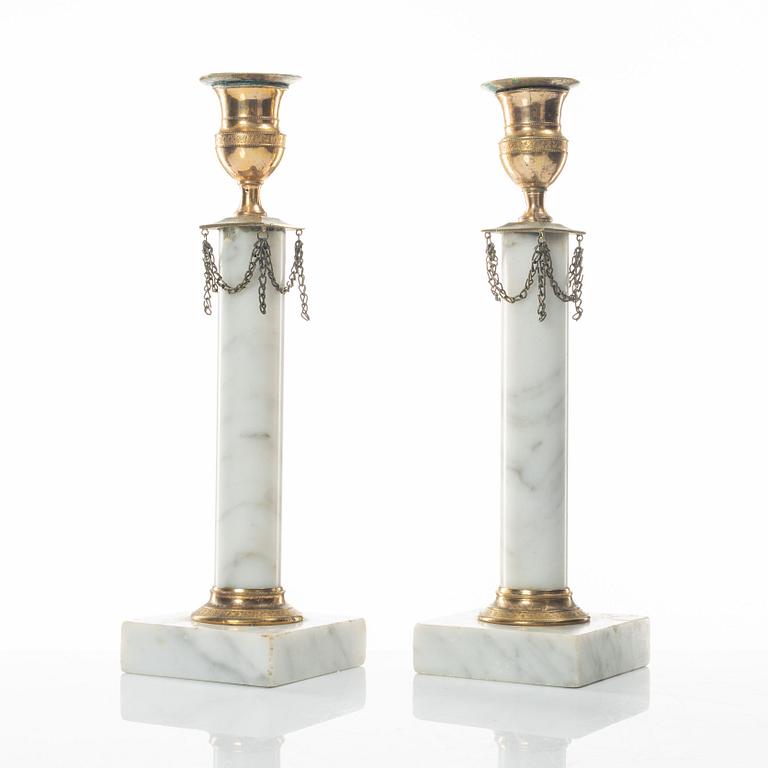 A pair of gilt-brass and marble late Gustavians candlesticks, late 18th century.