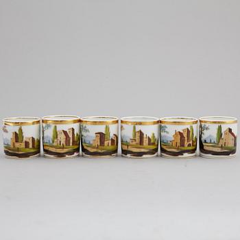 A group of seven cups, one with dish, Germany and France, 19th century.