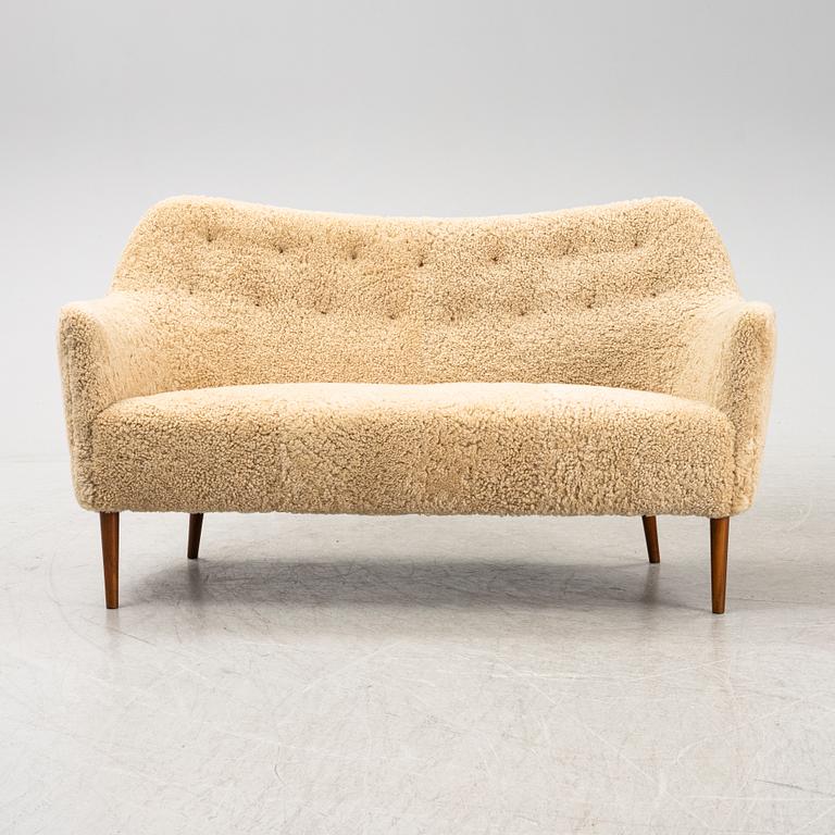 A mid 20th Century sofa with teak legs and new sheepskin upholstery, possibly by Carl Brorup, Slagelse, Denmark.