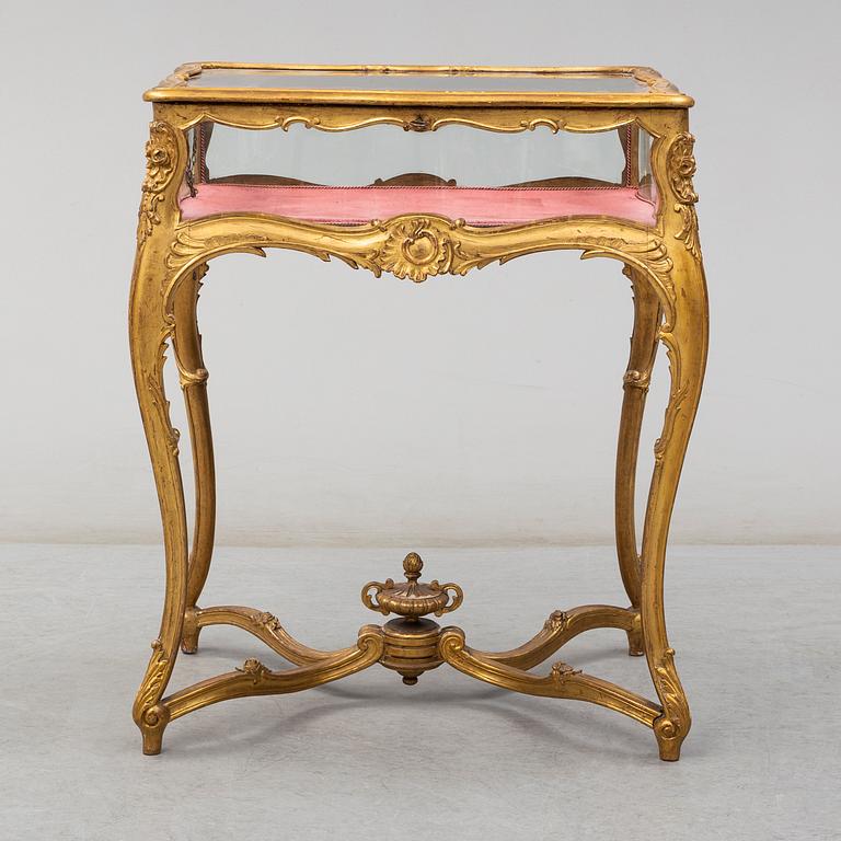 A Louis XV style display table, first half of the 20th century.