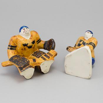 LISA LARSON, two stoneware figurines, "Ishockeyspelare", Gustavsberg. Designed in 1973.