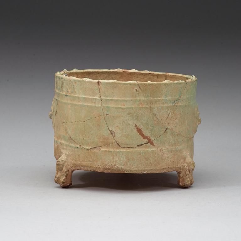 A green glazed tripod censer, Han dynasty (206 BC - 220 AD).