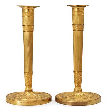 677. A pair of French Empire early 19th century candlesticks.