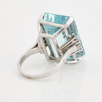 A emerald cut aquamarine and brilliant cut diamond ring.