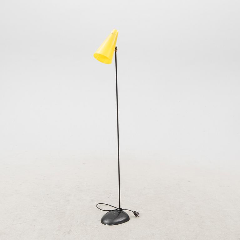 A 1050s metal and plastic floor lamp.