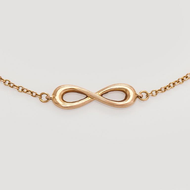 Tiffany & Co, an 18K gold 'Infinity Endless' bracelet.