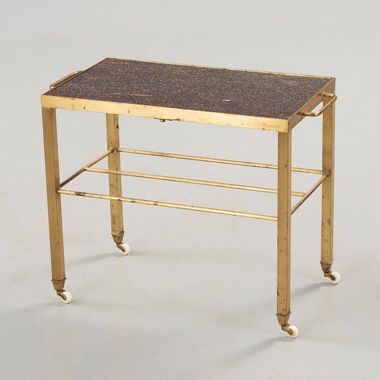 A Swedish mid 20th century brass and porphyry serving trolley.