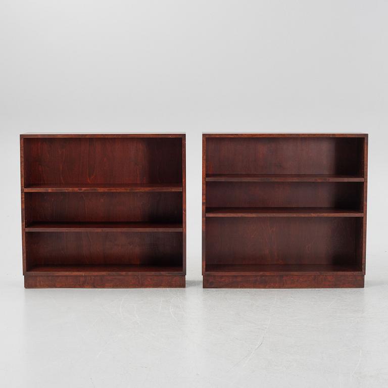 A pair of stained birch book cases.