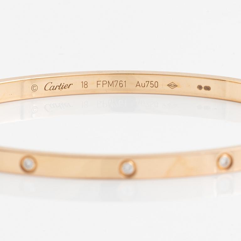 A Cartier "Love" bracelet small model in 18K rose gold with ten round brilliant-cut diamonds.