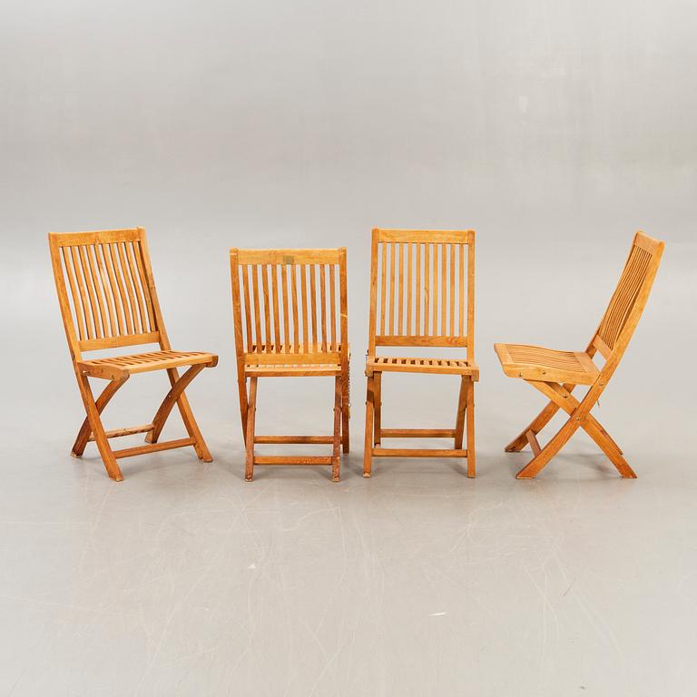 A set of four chairs and a table Royal teak and others, later part of the 20th century.