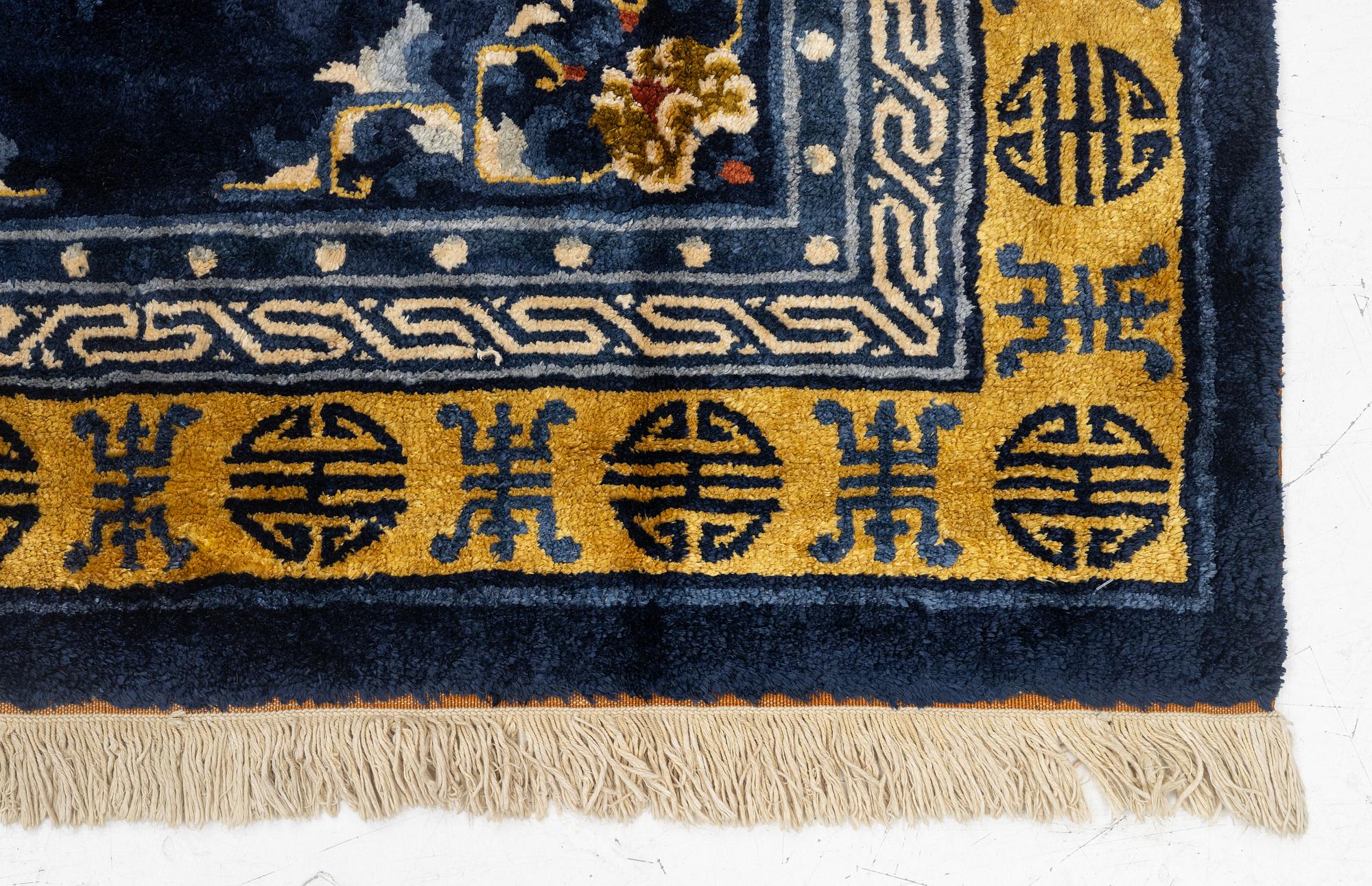 A semi-antique silk Chinaese 'Antique finish' rug, c. 175 x 122 cm.