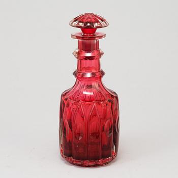 A MID 19TH CENTURY RED GLASS DECANTER AND STOPPER.