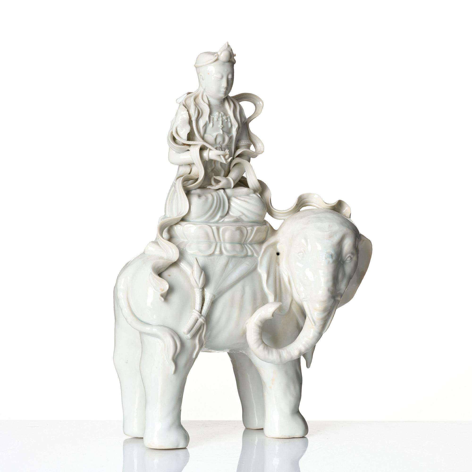 A large blanc-de-chine figure of Guanyin riding an elephant, late Qing dynasty/early 20th Century.