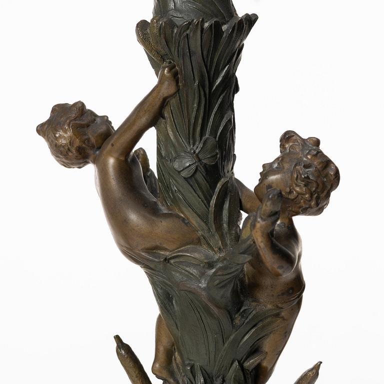 a pair of bronze and marble candle sticks, after a model by Houdon, late 19th century.