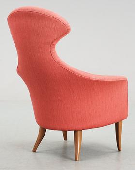 A Kerstin Hörlin Holmquist easy chair "Stora Eva " and a table "Äpplet", in the set of furniture called 'The Paradise'.